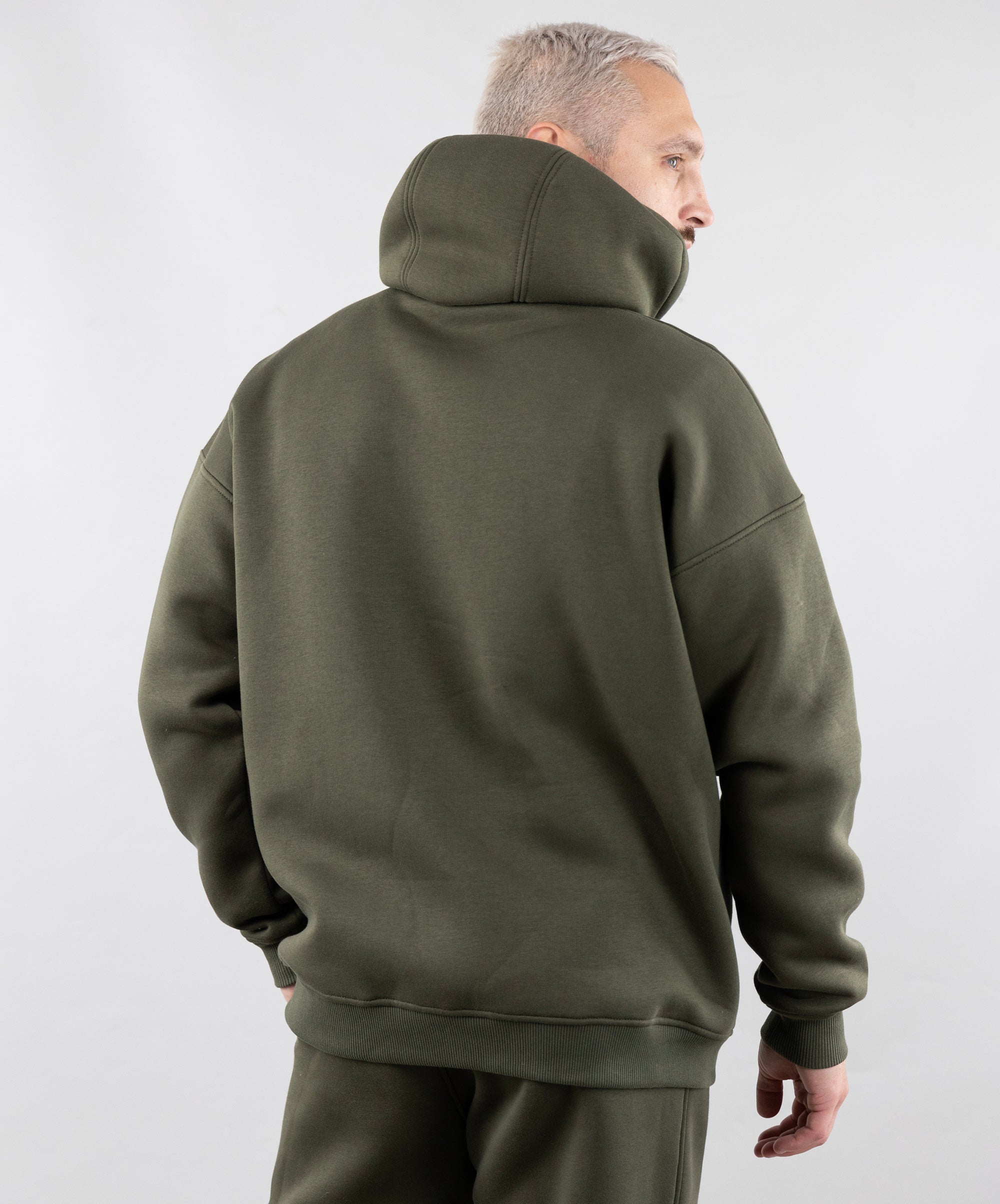 Warm Oversize Hoodie "Introvert". Khaki. Man from the back